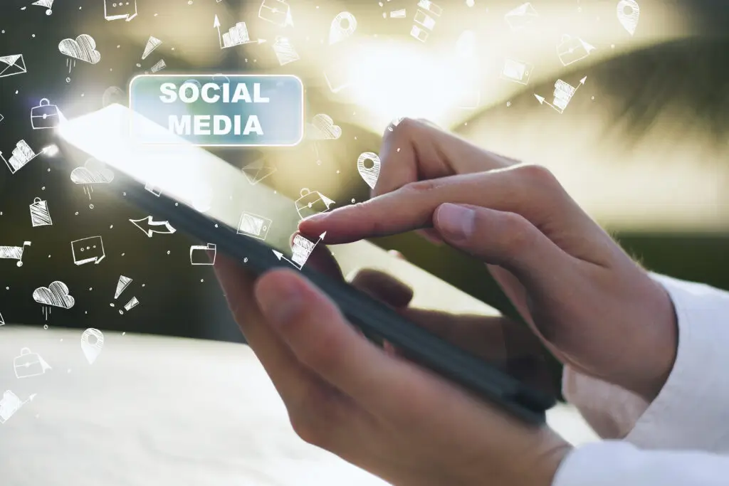 Person using smartphone with social media icons