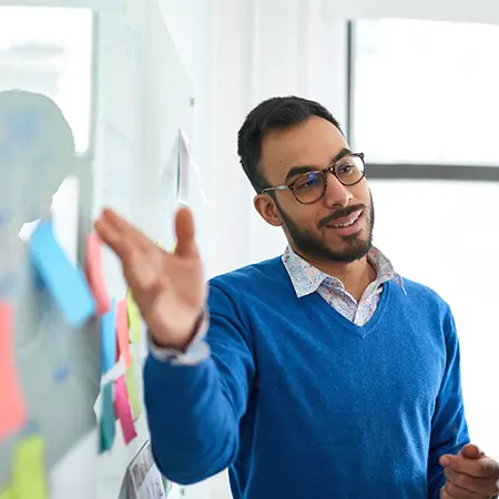 Social media strategist using a whiteboard for a client campaign