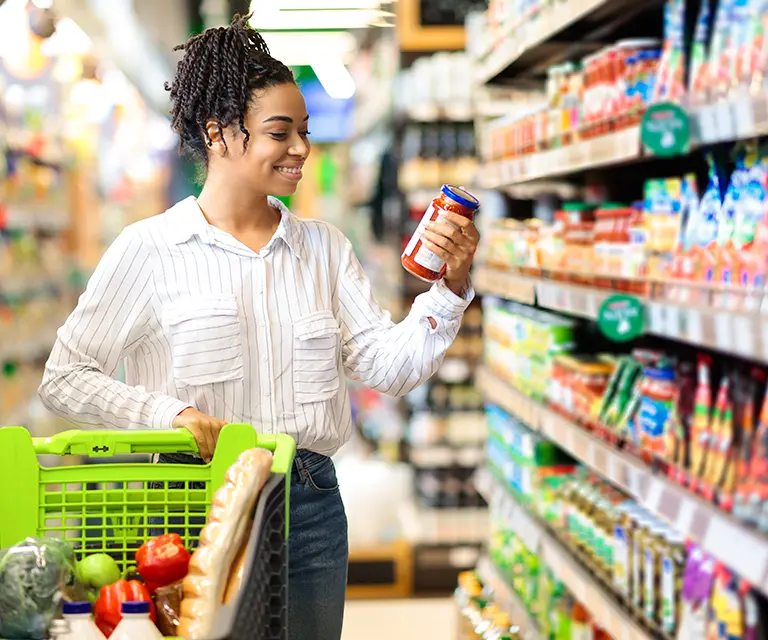 Woman looking at CPGs in a supermarket